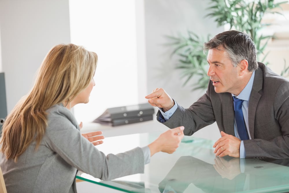 A blonde businesswoman and a mature businessman having an argument in an office-1